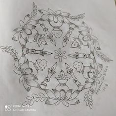 a drawing of flowers and birds in a circle with leaves around it, on top of a piece of paper