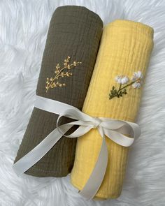 two yellow and green towels with flowers on them