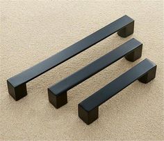 three black benches sitting on top of a carpeted floor