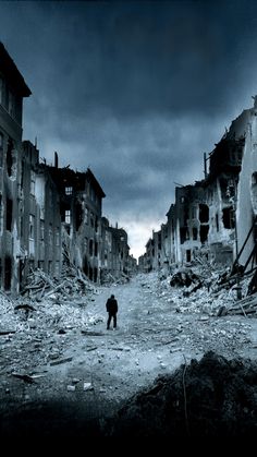 a man standing in the middle of a destroyed city street with buildings on both sides