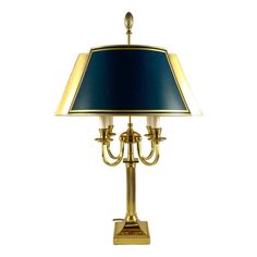 a brass table lamp with a blue shade