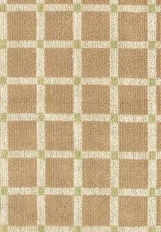 a brown and white checkered rug with green accents