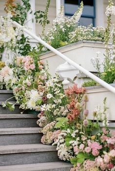 a bunch of flowers that are on some steps