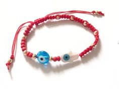 "Pulsera Mal de Ojo This bracelet is half woven with macrame square knot with a red cotton-linen cord. The other half bracelet it's beaded with 4mm red seed beads and 4mm gold filled balls. At the center has a 1 cm white mother of pearl with blue evil eye and a 1.5 cm round glass blue evil eye. Bracelet minimum size is 6\" or 15 cm, and can be extended to 8\" or 20cm approximately. This cute bracelet can be adjusted to a different length if needed. It's a great look for daytime, clean line, fash Red Macrame Beaded Bracelets For Friendship, Red Macrame Braided Bracelets For Friendship, Red Macrame Jewelry For Beach, Bohemian Red Friendship Bracelets With Adjustable Length, Red Bohemian Friendship Bracelets With Adjustable Length, Red Adjustable Friendship Bracelets For Beach, Red Macrame Friendship Bracelets For Beach, Red Beaded Bracelets With Sliding Knot For Beach, Adjustable Red Macrame Bracelets