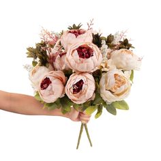 a person holding a bouquet of flowers in their hand