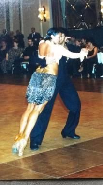 a man and woman dancing on a dance floor