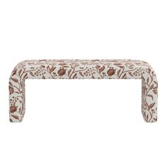 an upholstered bench with flowers and leaves on the top, against a white background