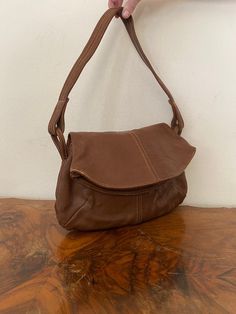 "Vintage Brown Leather purse, shoulder bag, 1970s, slightly distressed, Boho purse, Whiskey brown, Hippie purse Nice solid all leather 1970s brown leather purse Good condition, sound construction some light marks on the back. No damage Flap over closure 3 seperate sections. 1 zippered 1 center 1 large main section Measurements: 9\" x 13\" x 3\" Strap drop: 15\" NK528DR Vintage Brown Leather purse, shoulder bag, 1970s, slightly distressed, Boho purse, Whiskey brown, Hippie purse" Retro Brown Satchel With Removable Pouch, Vintage Brown Bag For Everyday Use, Retro Brown Satchel For Everyday Use, Retro Vintage Brown Shoulder Bag For Everyday, Retro Brown Leather Shoulder Bag, Vintage Distressed Brown Bag For Everyday, Retro Cognac Shoulder Bag For Everyday Use, Retro Vintage Brown Soft Leather Bag, Vintage Brown Shoulder Bag For Everyday