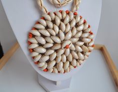 fantastic art work! a real piece of art! Enormous Papua New Guinea tribal COWRIE SHELL ceremonial statement NECKLACE with huge crocheted circular medallion pendant with some small orange painted shells ; medallion : 4.5'' inches DIAMETER; 31'' INCHES without the medallion ; 151 gr  good vintage condition with imperfections expected from a handcrafted item made of organic material - sold as is. IMPORTANT TO READ: To make this a smooth and pleasant transaction experience for everyone, all buyers need to read and understand the description, the terms of sale , the payment and the shipping indicated in this listing. TERMS OF SALE A. SHIPPING WORLDWIDE This listing includes the shipping fees indicated below. B. CARRIERS We don't ship with FedEx, DHL or UPS or any other carrier except for Canada Unique Medallion Necklaces For Festivals, Handmade Bohemian Medallion Necklace, Artisan White Necklaces For Festivals, Traditional Natural Color Round Jewelry, White Bohemian Necklace With Large Pendant, Bohemian White Necklace With Large Pendant, Traditional Shell Necklace Gift, White Medallion Amulet Necklace, White Amulet Style Medallion Necklace