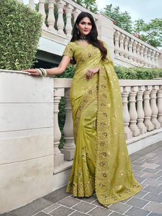 Unveil the epitome of sophistication with this stunning Green Pure Tissue Silk Saree, featuring intricate embroidery, sparkling stones, pearls, and authentic mirror work along the borders. Perfectly crafted for wedding ceremonies, upscale parties, and special occasions, this saree radiates timeless elegance. Versatility in Shades and Fabrics: The green hue of this saree offers a refreshing touch of vibrancy, while the pure tissue silk fabric provides a luxurious texture. The blend of embroidery, Drapping Saree, Dress Saree, Tissue Silk Saree, Chartreuse Green, Party Kleidung, Designer Saree, Traditional Sarees, Designer Sarees