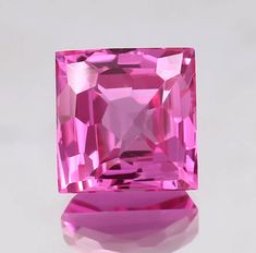 a pink diamond sitting on top of a table