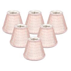 six pink lampshades with white trims on the bottom and one light in the middle