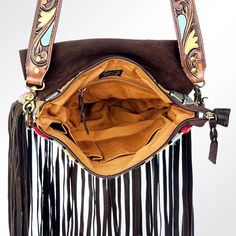 Bring some boho vibes to your outfit with our Saddle Blanket Handbag. Made from a unique saddle blanket material, this handbag is perfect for on-the-go style. With its spacious design, it's perfect for carrying all your essentials while adding a touch of rustic charm. A meticulously hand weaved wool saddle blanket giving it a western traditional yet trendy and elegant look.High quality Genuine Full Grain Leather. Soft and supple leather that ages beautifully as it wears.Decorated with beautiful Multicolor Fringe Crossbody Bag, Rectangular Fringe Bucket Bag For Travel, Bohemian Satchel With Leather Top Handle, Fringe Pouch Bag For Everyday Use, Bohemian Satchel With Leather Handles, Multicolor Fringe Crossbody Shoulder Bag, Travel Fringe Pouch Shoulder Bag, Bohemian Bag With Detachable Strap For Daily Use, Bohemian Bag For Daily Use With Detachable Strap