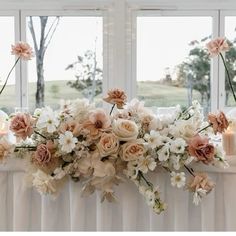 a table topped with flowers and candles