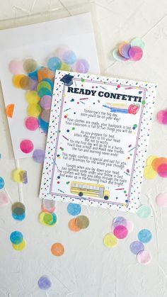 the ready confetti card is next to some confetti on a table