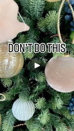 two ornaments hanging from a christmas tree with the words, don't do this