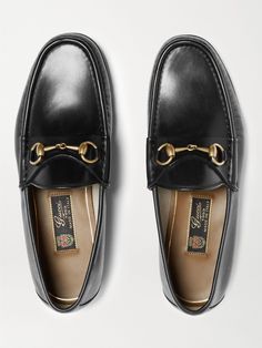 Gucci's iconic loafers were first introduced in 1953; it says a lot about the timelessness of the design that they've barely changed since. This glossy black version has been crafted in Italy from leather embellished with the hallmark horsebit that nods to the brand's equestrian heritage. Gucci Slip-on Formal Leather Shoes, Gucci Formal Slip-on Leather Shoes, Luxury Gucci Dress Shoes With Leather Sole, Timeless Loafers For Galas, Classic Gucci Calf Leather Shoes, Gucci Luxury Slip-on Dress Shoes, Classic Gucci Loafers With Leather Lining, Gucci Slip-on Dress Shoes With Leather Sole, Classic Gucci Dress Shoes In Calf Leather