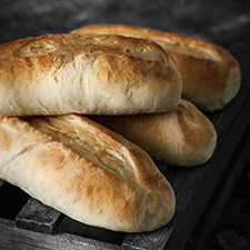 three loaves of bread sitting on top of a table