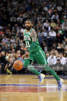 boston basketball player dribbling the ball in front of an audience during a game