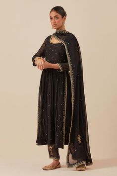 Black anarkali with sequin hand embroidery and gathered detail. Paired with embroidered pant.
Components: 2
Pattern: Embroidered
Type Of Work: Sequin
Neckline: Scoop
Sleeve Type: Sheer
Fabric: Chanderi
Color: Black
Other Details: 
Weight: 2 kgs
Length:
Anarkali: 47 inches
Pant: 37 inches
Model is wearing size S
Pant Closure: Elasticated back
Note: Dupatta worn by the model is not for sale
Occasion: Sangeet - Aza Fashions Festive Bollywood Black Palazzo Set, Transitional Anarkali Salwar Kameez For Party, Transitional Season Anarkali Salwar Kameez For Party, Traditional Chanderi Anarkali Set For Party, Black Cutdana Salwar Kameez For Navratri, Black Salwar Kameez With Cutdana For Navratri, Black Anarkali Set With Gota Work For Party, Party Anarkali Set With Gota Work In Black, Black Anarkali Style Palazzo Set For Diwali