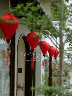 red lanterns hanging from the side of a building