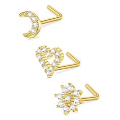 two gold ear clips with crystal stones on each end and a crescent shaped nose ring