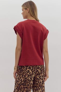 Unleash your inner fashionista with our Brittany Braided Cuff Top! This unique women's top features short sleeves with a playful braided design, making it the perfect layering piece for any outfit. Stand out with this versatile and stylish addition to your wardrobe. Details Round Neck Cap Braided Sleeve Knit 84% Cotton, 16% Polyester Sizing Becca is 5'6" and wearing a size Trendy Short Sleeve Top For Casual Gatherings, Trendy Short Sleeve Top For Summer Casual Gatherings, Unique Women Tops, Braid Cuffs, Cuffed Top, Long Sleeve Outerwear, Romper Dress, Short Sleeved Sweaters, Athletic Wear