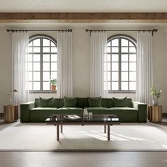 a living room with two large windows and a green couch in front of the window