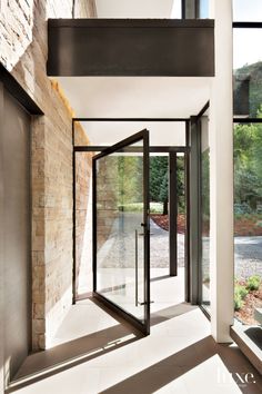 an empty hallway with glass doors leading to the outside