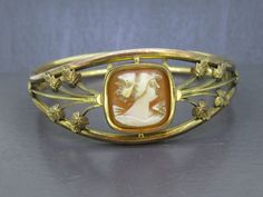 Beautiful antique cameo bracelet, not marked gold filled but tested and guaranteed.  Has light age related wear and patina.  Interesting clasp type, never seen it before but it works great.  Carved cameo looks great! Visit Ribbons Edge for more great pieces of vintage and antique jewelry!  All items added to your cart at Ribbons Edge will automatically combine shipping. To stay up to date with my newest offerings, follow me on IG @ RibbonsEdge Vintage Yellow Gold Cabochon Bracelets, Art Nouveau Oval Cameo Jewelry, Antique Gold Cabochon Bracelets, Antique Gold Bracelets With Cabochon, Gold Art Nouveau Jewelry With Intaglio, Victorian Gold Bracelets With Cabochon, Collectible Gold Bracelets With Cabochon, Elegant Gold Cameo Bracelets, Vintage Cameo Bracelet Jewelry