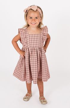 Bold ruffles bring playful energy to this adorably checked dress with a flared skirt that will look precious on your kiddo. Cotton lining 100% polyester Hand wash, line dry Imported Gingham Dresses With Ruffles For Picnic, Gingham Dress With Ruffles For Picnic, Picnic Gingham Dress With Ruffles, Gingham Dress With Ruffled Hem And Straps, Plaid Ruffled Dress For Picnic, Playful Ruffled Dresses For Picnic, Gingham Dress With Ruffled Straps And Details, Gingham Dress With Ruffled Straps And Ruffles, Plaid Sleeveless Dress With Ruffle Hem