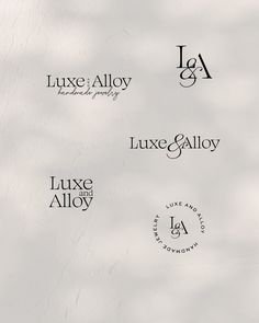 four different logos for luxury jewelry and accessories, all in black on white paper with shadows