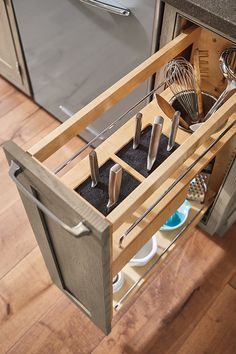 an open drawer with utensils in it