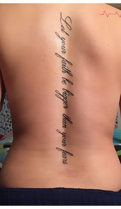 the back of a woman's upper body with writing on her lower back and side