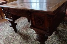 an old wooden table in the middle of a living room