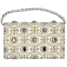 This vintage ornately embroidered and decorated clutch styled evening handbag was made in India in approximately 1940 in the period Anglo-Indian style. The outer shell of the purse is constructed of a heavy cotton with has been intricately embroidered with a combination of gold and silver toned wire and accented with inset cabachon polished stones. The earth tones of the cotton exterior are accented with silk lining and compartments, and is secured with a large snap clasp. The purse is labelled Purse Handmade, Silk Bag, Silver Bags, Vintage Clutch, Clutch Purse Evening, Fashion Collage, Evening Handbag, Evening Purse, Vintage Purse