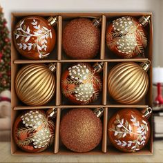 a box filled with christmas ornaments on top of a wooden table