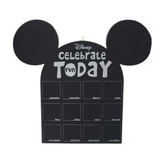 a black mickey mouse calendar with the words celebrate today on it's face and ears