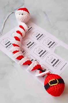 a crocheted wormel toy sitting on top of a piece of paper