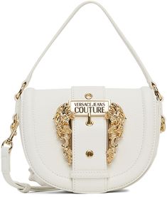 Grained faux-leather shoulder bag in white. · Carry handle at top · Adjustable and detachable shoulder strap · Logo-engraved pin-buckle hardware at face · Foldover flap with magnetic press-stud fastening · Patch pocket and zippered pocket at interior · Logo-woven twill lining · H7 x W7.50 x D2 in Supplier color: White | Versace Jeans Couture White Couture I Bag White Shoulder Bag With Logo Hardware, White Top Handle Shoulder Bag With Logo Hardware, Chic White Shoulder Bag With Logo Hardware, White Crossbody Shoulder Bag With Logo Hardware, White Bags With Double Handle And Logo Hardware, White Double Handle Shoulder Bag With Logo Hardware, White Top Handle Shoulder Bag With Metal Hardware, Formal White Shoulder Bag With Metal Hardware, White Flap Crossbody Bag With Gold-tone Hardware