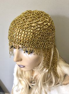 "Sassy headdress hat with all over shiny beads and fringe in front and back. Beads hang 4\"-6\" in the back and 1\" front with Stretch to fit around entire head. Color: Gold" Elegant Rhinestone Fringe Headpiece For Party, Elegant Party Headpiece With Rhinestone Fringe, Bohemian Headpiece For Mardi Gras Party, Flapper Headpieces For Costume Party, Adjustable Rhinestone Headpiece For Festival, Adjustable Rhinestone Festival Headpiece, Fitted Flapper Headpieces For Costume Party, Adjustable Festival Headpiece With Rhinestones, Bohemian Mardi Gras Party Costume Headpiece