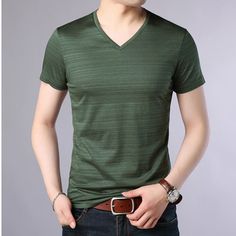 When a cool dude is your style, amp it up with Noah. This stretchable t-shirt features a basic style on a regenerated fiber blend. It's detailed into a V neckline with short sleeves laid out on a slim fit and a regular length. Styling Tips: Throw on a leather jacket and our Evander denim pants with this one. Color: Green, White, Black, Burgundy, BeigeSleeve Length: ShortSilhouette: SlimNeckline: V NeckMaterial: Cotton Fabric: 95% Cotton, 5% SpandexFit Type: FittedImported Update: This product is Stretch V-neck T-shirt For Summer, Casual Stretch V-neck T-shirt, Casual V-neck Stretch T-shirt, Cool Dude, Styling Tips, Basic Style, V Neck Tee, One Color, Denim Pants