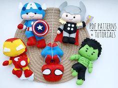 the avengers plush toys are hanging on a rope