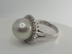 This is a very cool, imperfect, art deco glass pearl ring with CZ in 925 sterling This ring is in size 7, we do not recommend resizing because it may tend to break this GLASS pearl There is a discoloration as in the photos East Village Bangles is the product of love ❤️, a unique collection of vintage jewelry painstakingly restored by Casey in the East Village. Even as we put love, sweat (and sometimes tears!) into restoring these items, it is our policy that you must be thrilled. We stand behind every item and we will take it back if it is not for you. Unique White Gold Pearl Ring For Formal Occasions, Unique White Pearl Ring For Formal Occasions, Elegant Sterling Silver Cabochon Pearl Ring, Silver Pearl Ring With Gemstone For Formal Occasions, Imperfect Art, Gemstone Rings Vintage, Art Deco Glass, Ring Art Deco, East Village