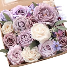 a box filled with lots of purple and white flowers