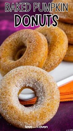 baked pumpkin donuts on a plate with the words baked pumpkin donuts above them