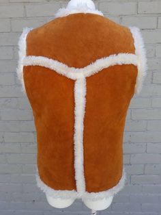 Suede and shearling sherpa vest by PYPSA. This fabulous brown vest features super cozy sheepskin lining. It also has 2 buckle clip closures and two front waist pockets. Made in MexicoTag reads 38, this is best suited to a small, possibly medium.Measurements taken with vest laying flat:Length 26"Bust 38"Waist 38"Vest is in great vintage condition. The only issue is that it needs to be professionally cleaned. There is a pen mark on the front of vest. Other than that, no major staining but it is on Brown Sleeveless Vest For Cold Weather, Brown Sleeveless Vest With Faux Fur Lining, Fall Sheepskin Sleeveless Vest, Sleeveless Sheepskin Vest For Fall, Fitted Sleeveless Vest With Faux Fur Lining, Flora Nikrooz, Sherpa Vest, Brown Vest, Lace Nightgown