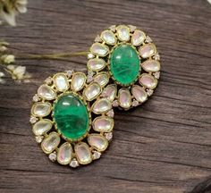 Polki emerald green kundan studs, inspired by Tyaani. Featuring moissanite and diamond accents, these jadau statement earrings capture timeless beauty and sophistication. Perfect for any special occasion, they make a stunning gift, blending traditional craftsmanship with modern luxury for a dazzling finish. *𝐏𝐑𝐎𝐃𝐔𝐂𝐓 𝐃𝐄𝐓𝐀𝐈𝐋* * Material: Brass * Plating: Gold Plated * Stone: Semi Precious Kundan & Polki. *𝐃𝐈𝐒𝐂𝐋𝐀𝐈𝐌𝐄𝐑* Product color may slightly vary due to photographic lighti Green Gemstone Temple Jewelry Earrings, Green Emerald Temple Jewelry Earrings, Green Earrings For Diwali, Green Emerald Earrings For Festivals, Emerald Green Earrings For Festivals, Green Jeweled Fusion Earrings, Emerald Earrings For Wedding And Festivals, Festive Emerald Earrings, Fusion Kundan Earrings With Stone Setting