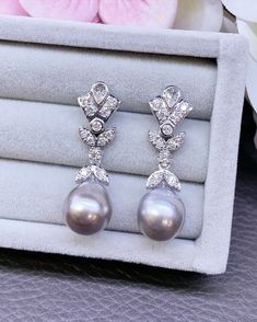 EXTREMELY SHINY, AUTHENTIC LUSTROUS GRAY TAHITIAN PEARLS! Dangling earrings! Perfect for any occasion!  We are presenting you A PAIR OF matching TAHITIAN PEARLS with natural, LUSTROUS BLACK color. SET IN HANDCRAFTED, 18K SOLID GOLD DROP EARRINGS. ACCENTED WITH 26 F/VS, SPARKLING ROUND BRILLIANT DIAMONDS! Extremely elegant and tasteful! The pearls are so lustrous and shiny! The design is chic and elegant. Simple and classy! Dangling with just enough length to show that you're important! With sparkling diamonds that will just make you look at yourself in the mirror and wonder "who is that with all that sparkle?".  IN CASE OF RETURN FOR US BUYERS. BUYERS MAY SEND THE ITEMS BACK TO OUR US-BASED OFFICE IN SALT LAKE CITY, UTAH ONLY ONE ITEM AVAILABLE!! NO DUPLICATES!! WHAT YOU SEE IN THE PICTURE Fine Jewelry Tahitian Pearl For Wedding, Tahitian Pearl Fine Jewelry For Wedding, Tahitian Pearl Wedding Jewelry, Silver Pear-shaped Pearl Earrings For Formal Events, Silver Pear-shaped Pearl Earrings For Formal Occasions, Pearl Drop Earrings For Wedding Fine Jewelry, Pearl Drop Earrings For Wedding, Wedding Fine Jewelry Pearl Drop Earrings, Formal Silver Pear-shaped Pearl Earrings