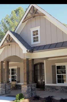 the front view of a house with stone pillars